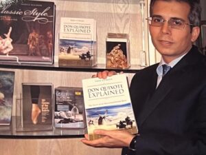 Man holding Don Quixote Explained book