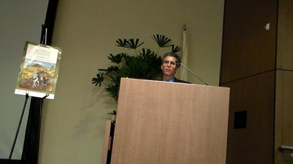 Speaker at podium in conference room