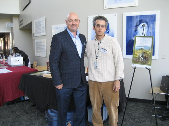 Two men at indoor exhibition with posters